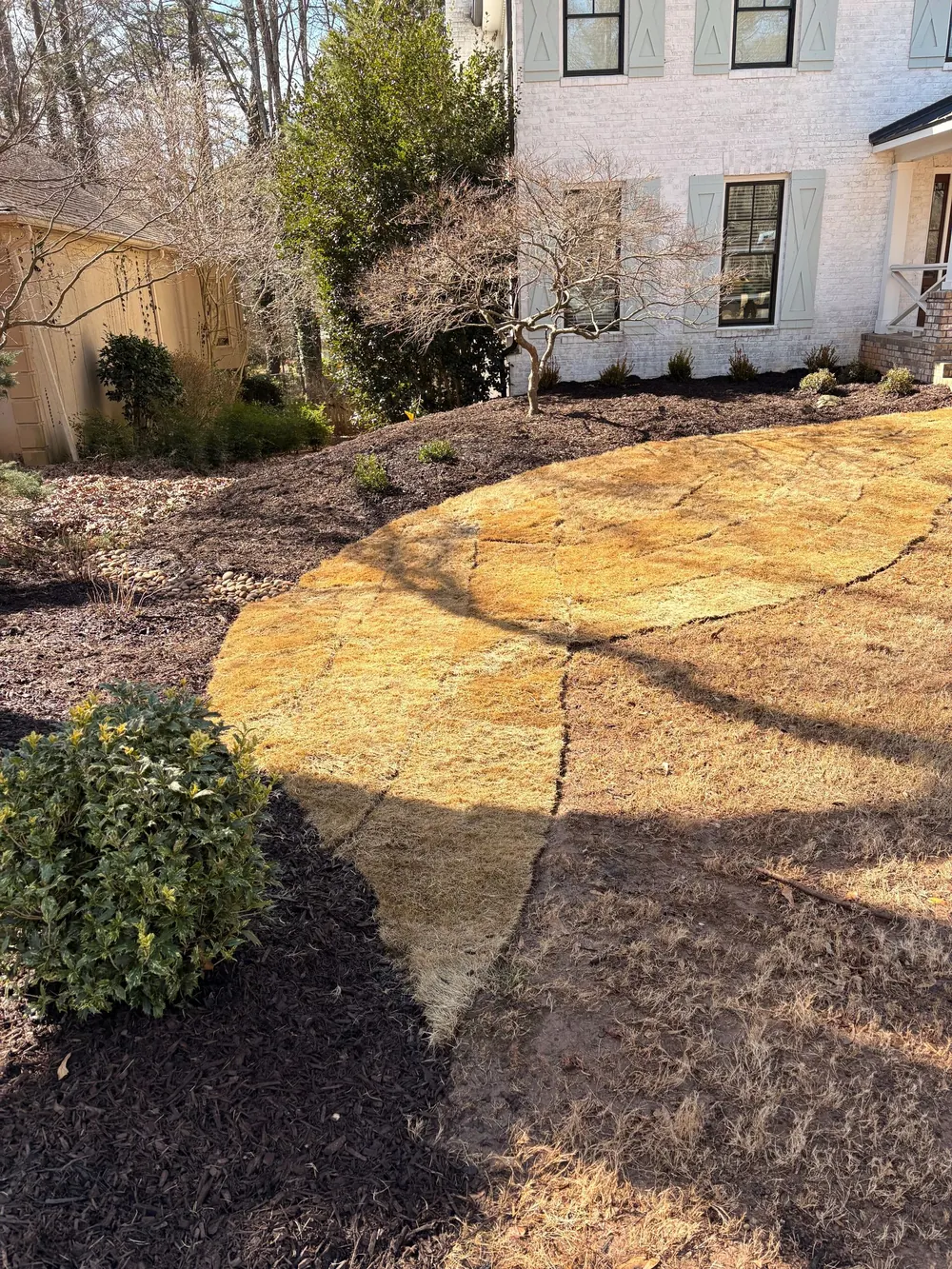 Flagstone patio bordered with fresh mulch